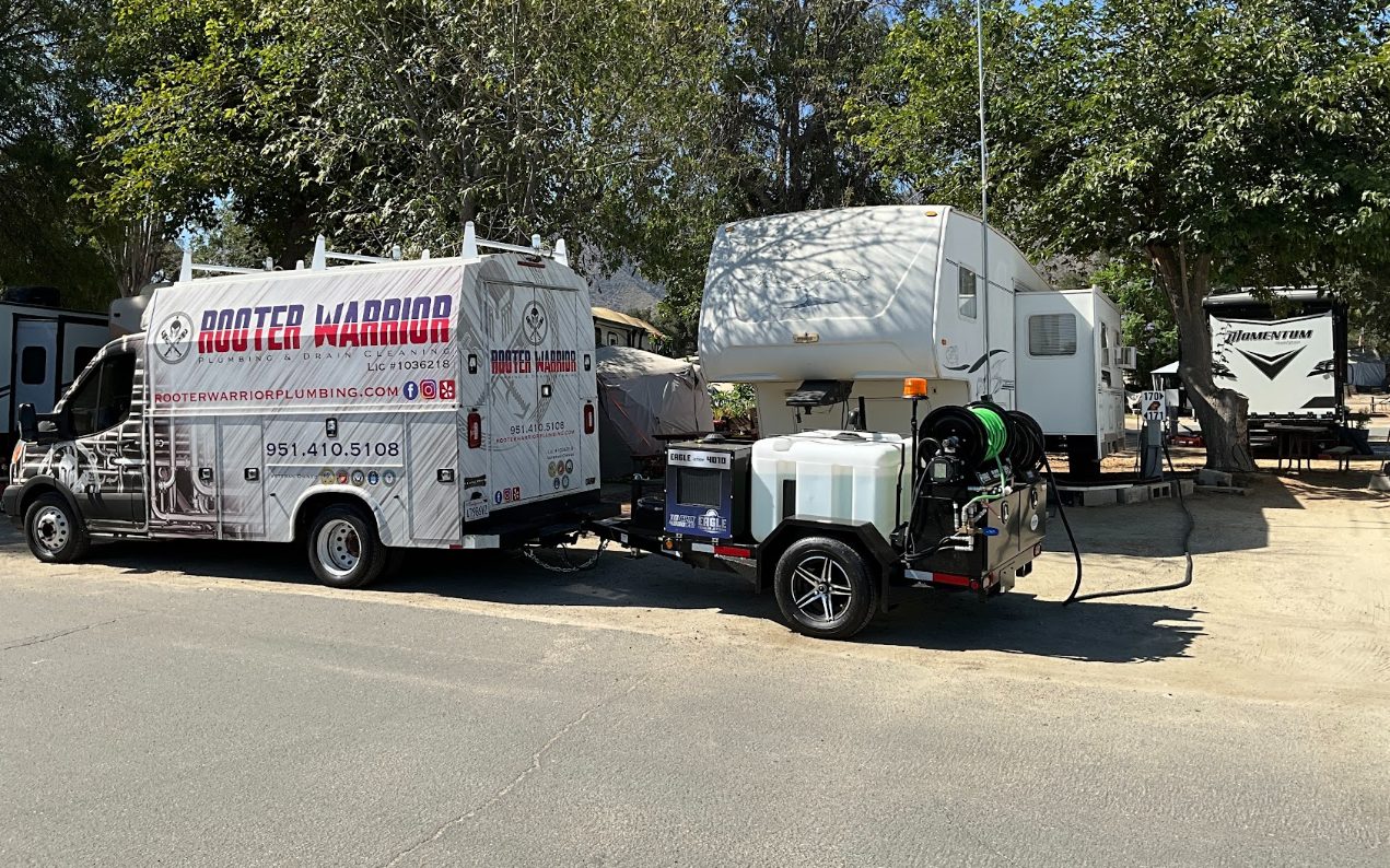 Rooter Warrior service truck towing the company's trailer-mounted hydro jetter
