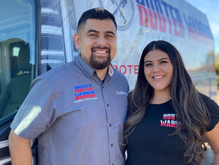 Guillermo and family in Rooter Warrior shirts in front of a service truck